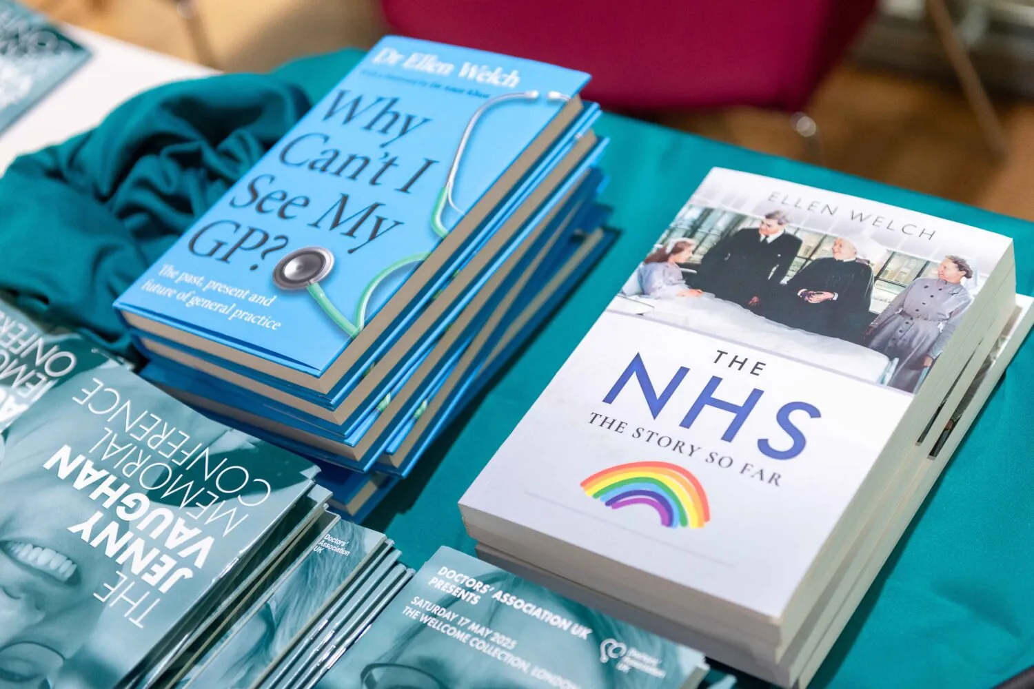 Piles of books and programmes at the arrival desk at the DAUK conference