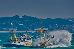 A fishing trawler heading out to sea