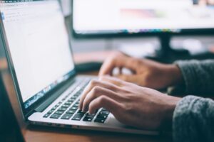 Someone typing on a laptop. Doctors for the NHS is asking for entries to its Peter Fisher Essay Prize 2025