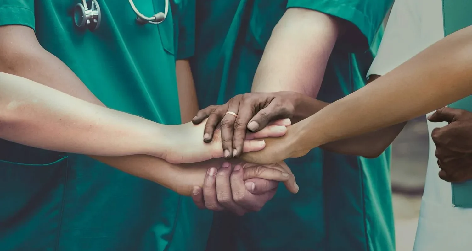 Stock image of doctors linking hands
