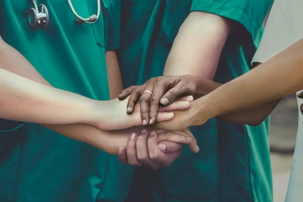 Stock image of doctors linking hands