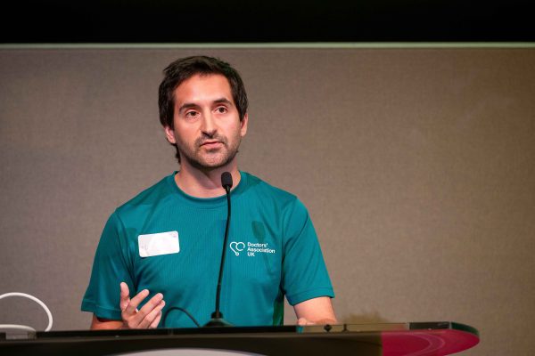 Photo of Dr Matt Lee, DAUK's sustainability lead, speaking at DAUK's conference.
