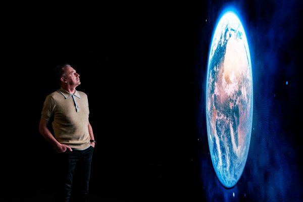 People's Emergency Briefing promotional still featuring Chris Packham looking at the Earth on a screen
