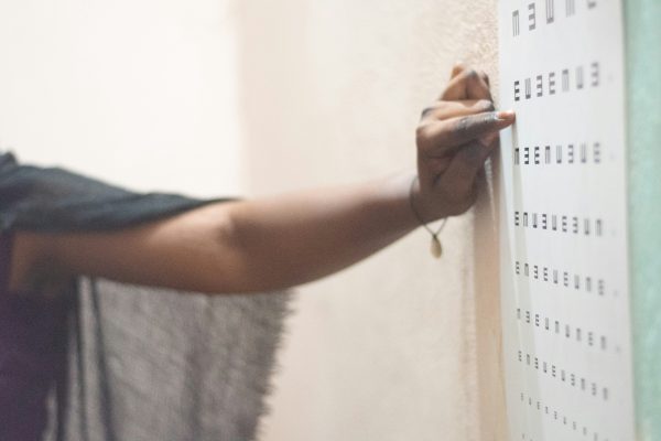 Optometrist pointing to an eye test board